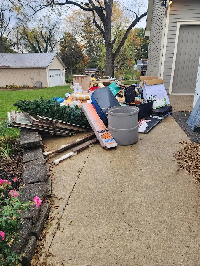 Dumpster being loaded with debris for Estate Cleanout Dumpster Rental in Oildale